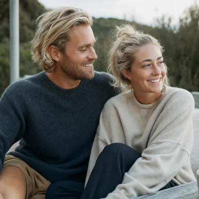 A happy couple sitting together outdoors